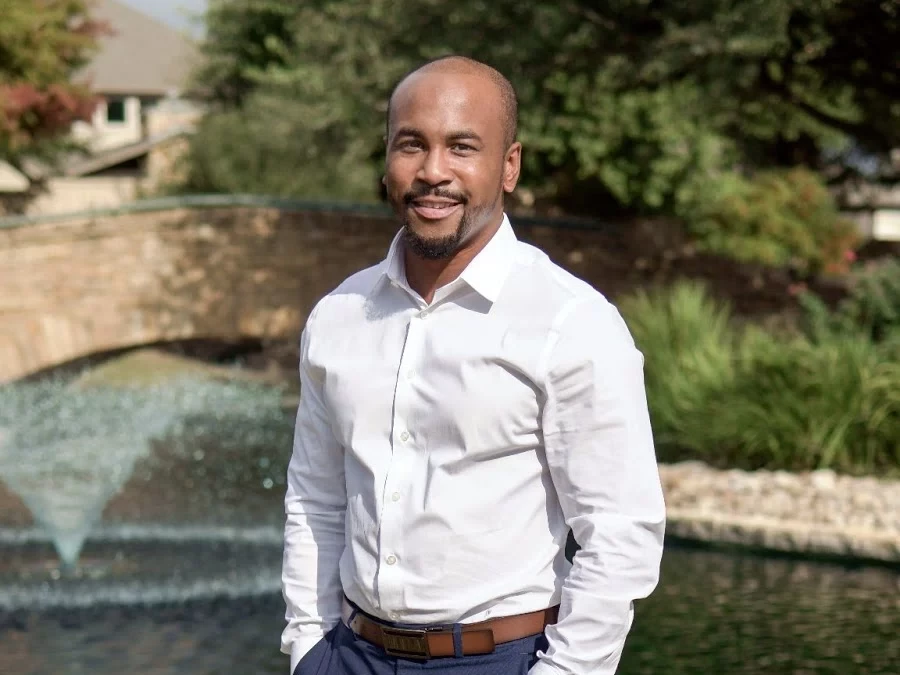 AnDrae’ Jones, MKG Marketing’s Business Development Representative, stands casually in front of a pond | MKG Marketing