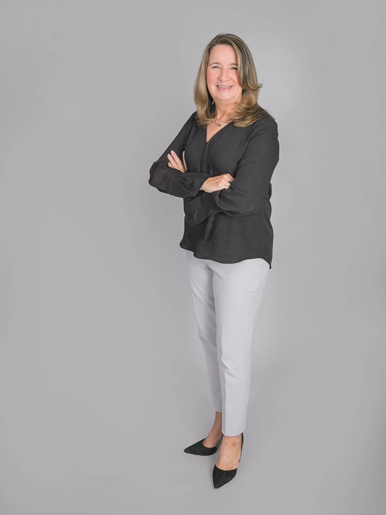 Kathy O’Brien, MKG Marketing’s Executive Assistant, in front of a gray background | MKG Marketing