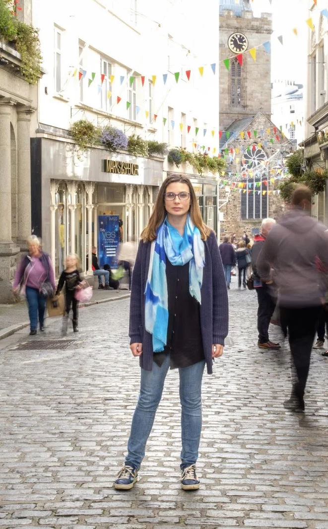 Kerry Guard, MKG Marketing’s Owner/CEO, stands on a street in Guernsey with the Town Church behind her | MKG Marketing